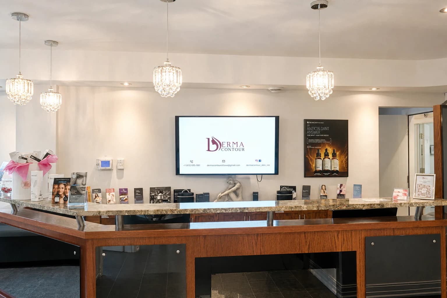 Front desk with chandeliers at Derma Contour Ottawa clinic